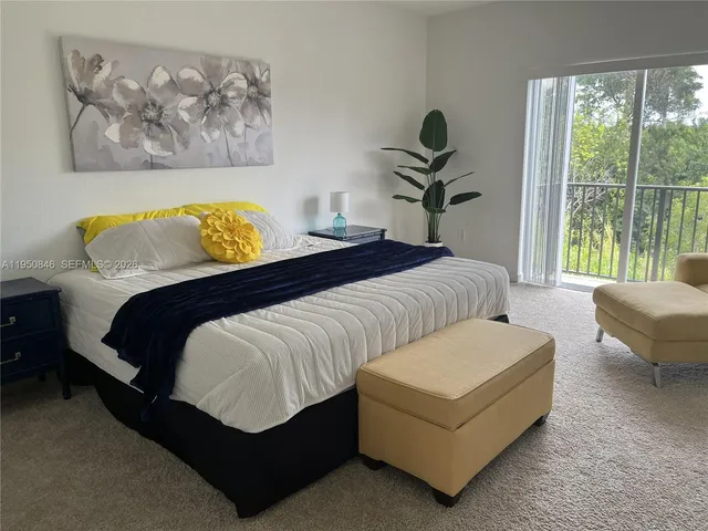 a bedroom with a bed a couch and a window