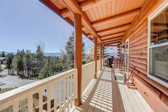 a view of balcony with wooden floor and fence