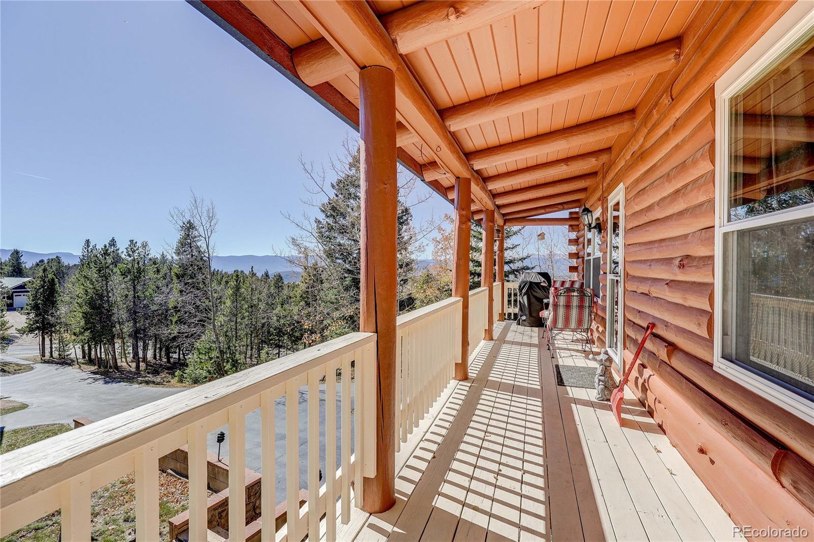 11142 Conifer Mountain Road Conifer, CO 80433 - Photo 13 of 50 a view of balcony with wooden floor and fence