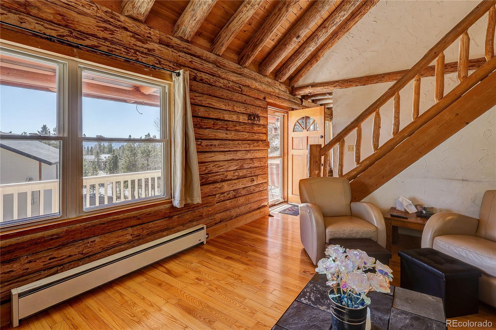 11142 Conifer Mountain Road Conifer, CO 80433 - Photo 16 of 50 a sitting area with wooden floors