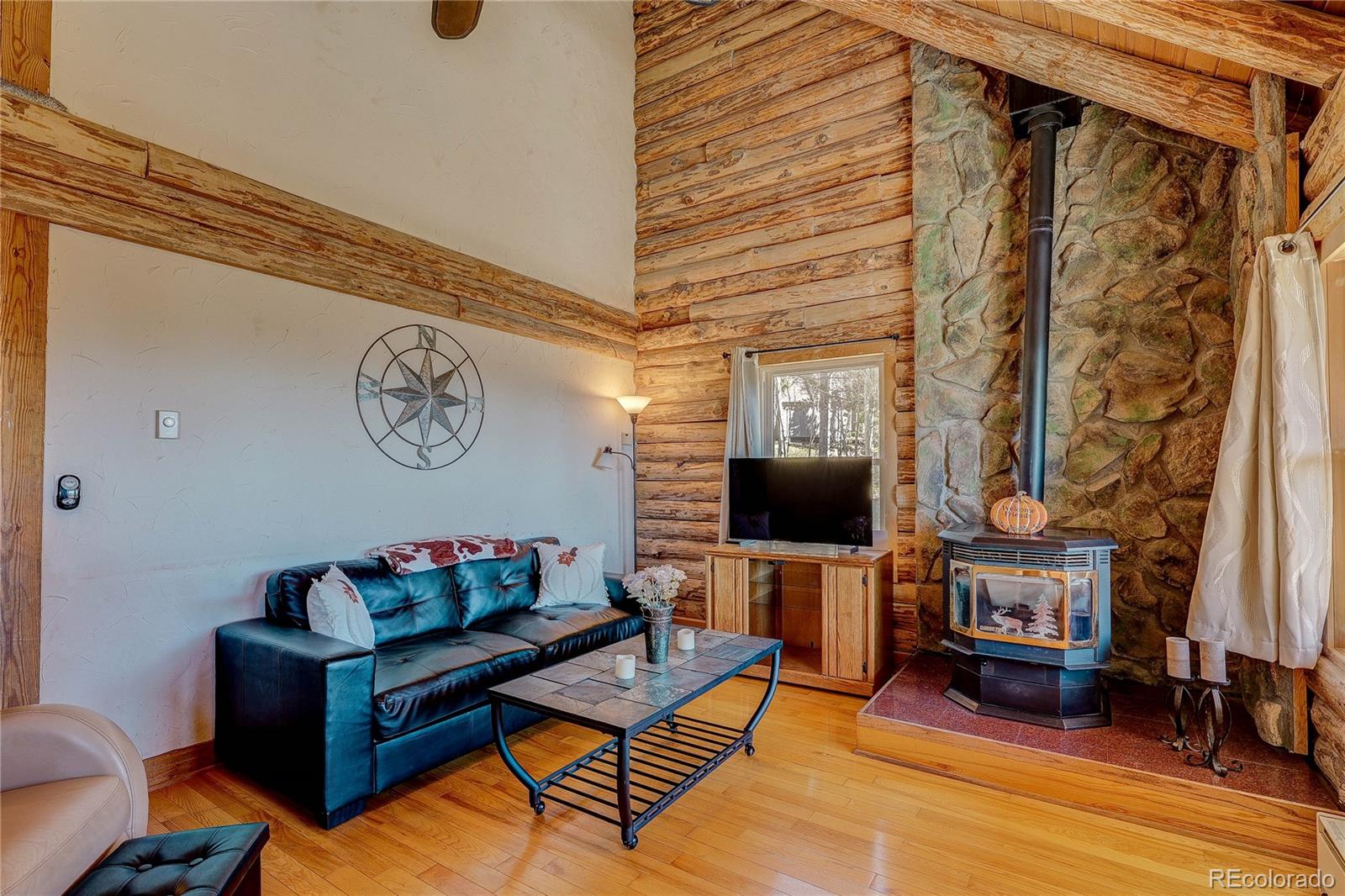 11142 Conifer Mountain Road Conifer, CO 80433 - Photo 17 of 50 a living room with furniture and a flat screen tv