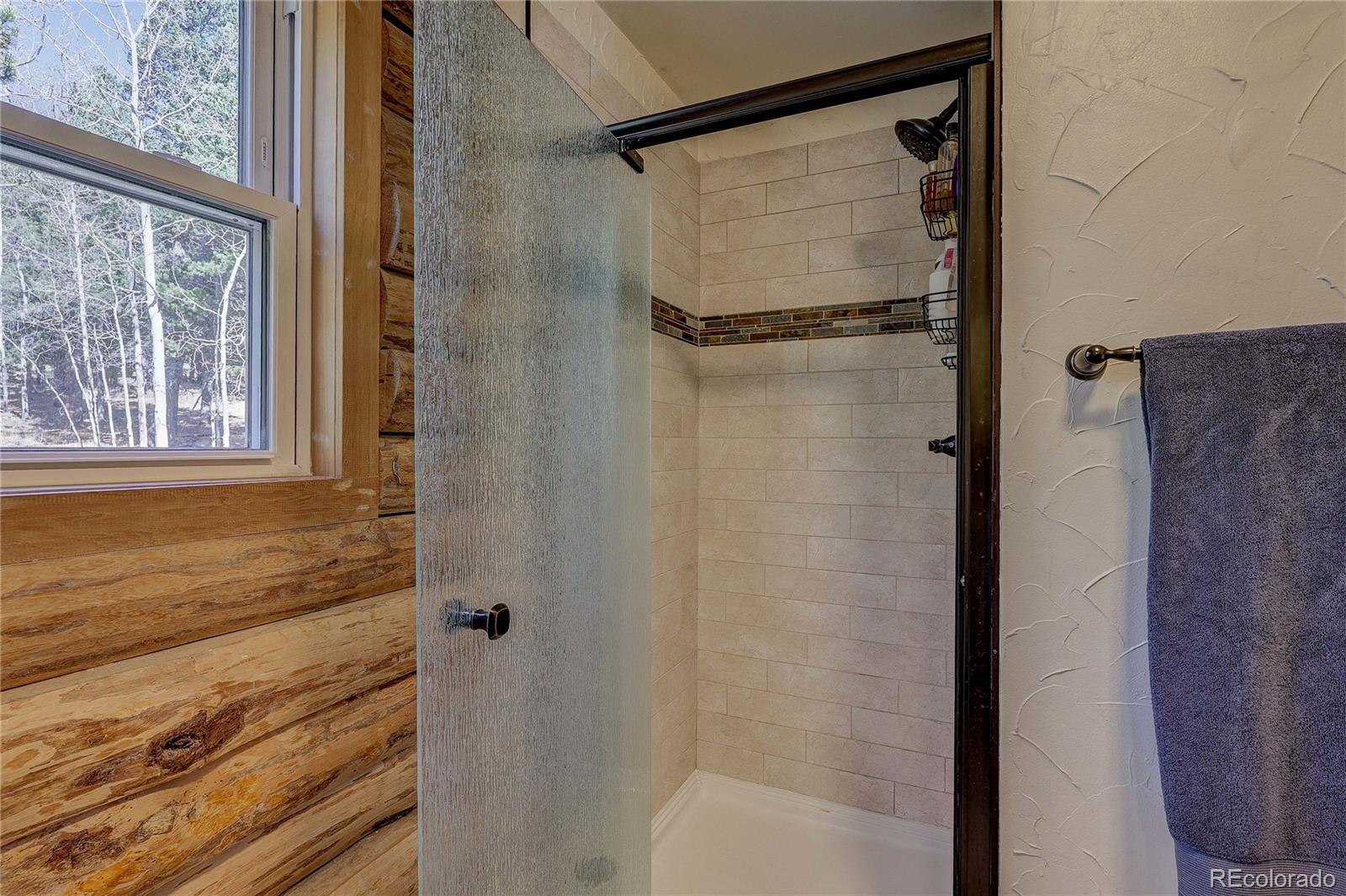 11142 Conifer Mountain Road Conifer, CO 80433 - Photo 27 of 50 a bathroom with a shower