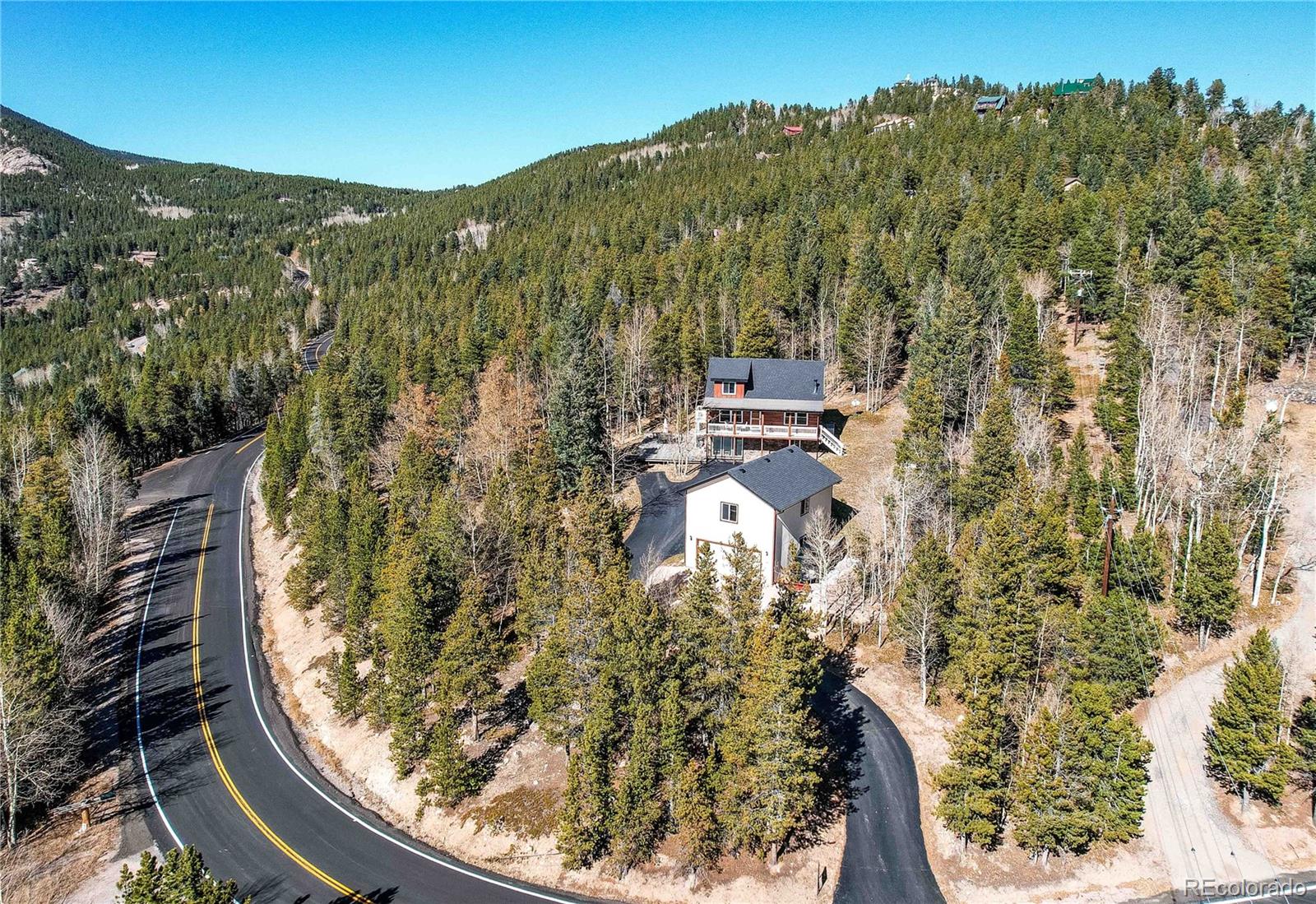 11142 Conifer Mountain Road Conifer, CO 80433 - Photo 3 of 50 a view of a wooden floor with a mountain in the background