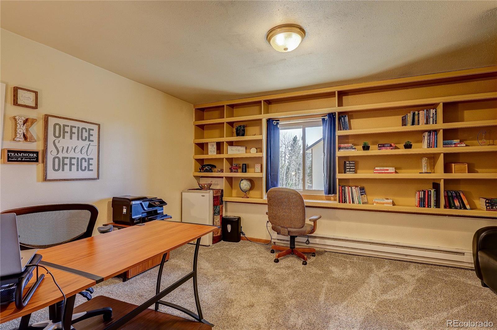 11142 Conifer Mountain Road Conifer, CO 80433 - Photo 32 of 50 a view of a workspace with furniture and a window