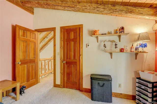 a view of a livingroom with wooden floor and shoes