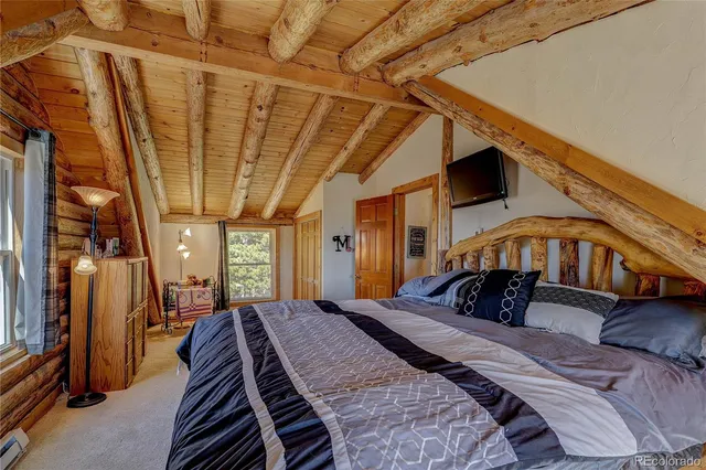 a bed room with a bed and a chandelier