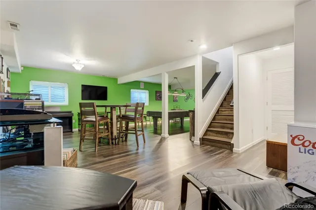 a dining room with furniture entryway and wooden floor