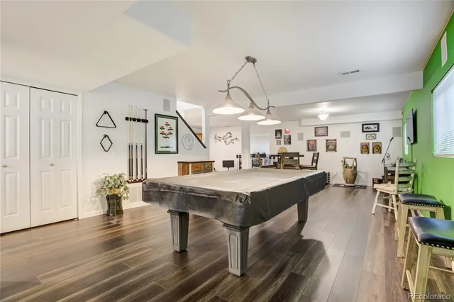 a large kitchen with a table and chairs