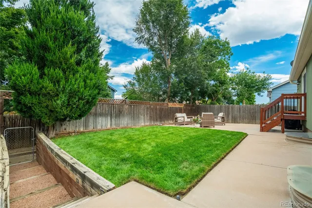 a view of a backyard with sitting area