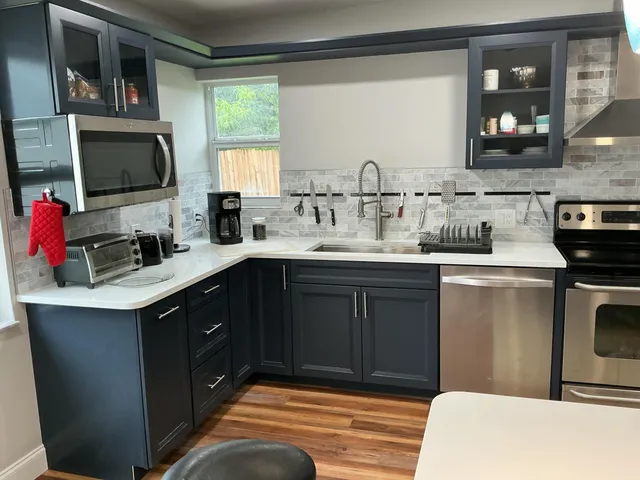 a kitchen with a sink a window and appliances