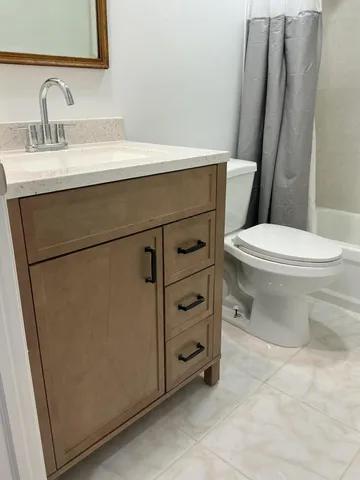 a view of a livingroom with furniture and a window