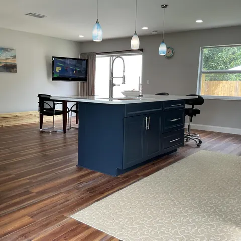a kitchen with a refrigerator and a stove
