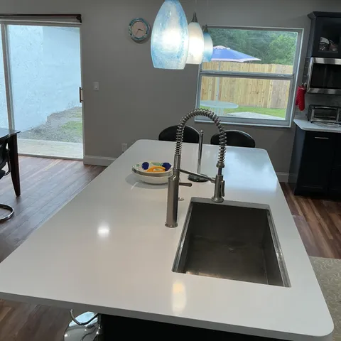 a kitchen with stainless steel appliances granite countertop a refrigerator sink and stove