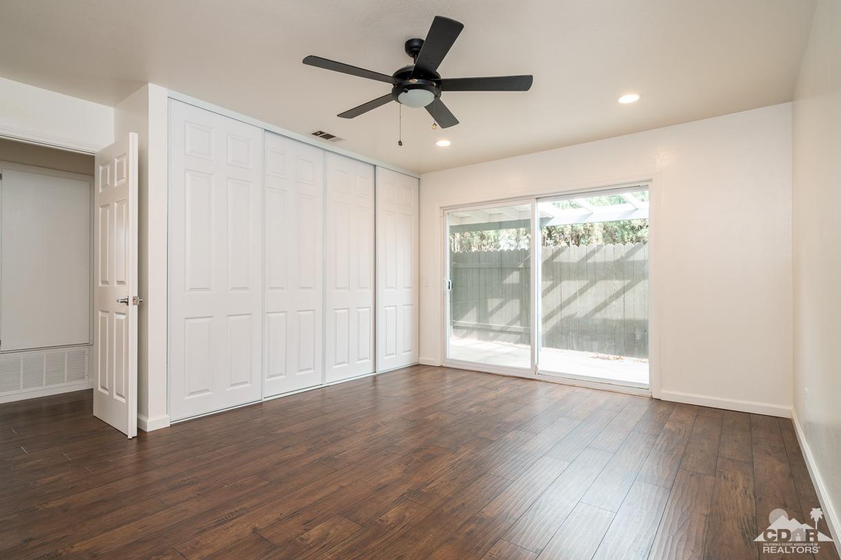 6987 Manhattan Drive Riverside, CA 92506 - Photo 12 of 28 a view of empty room with wooden floor and fan