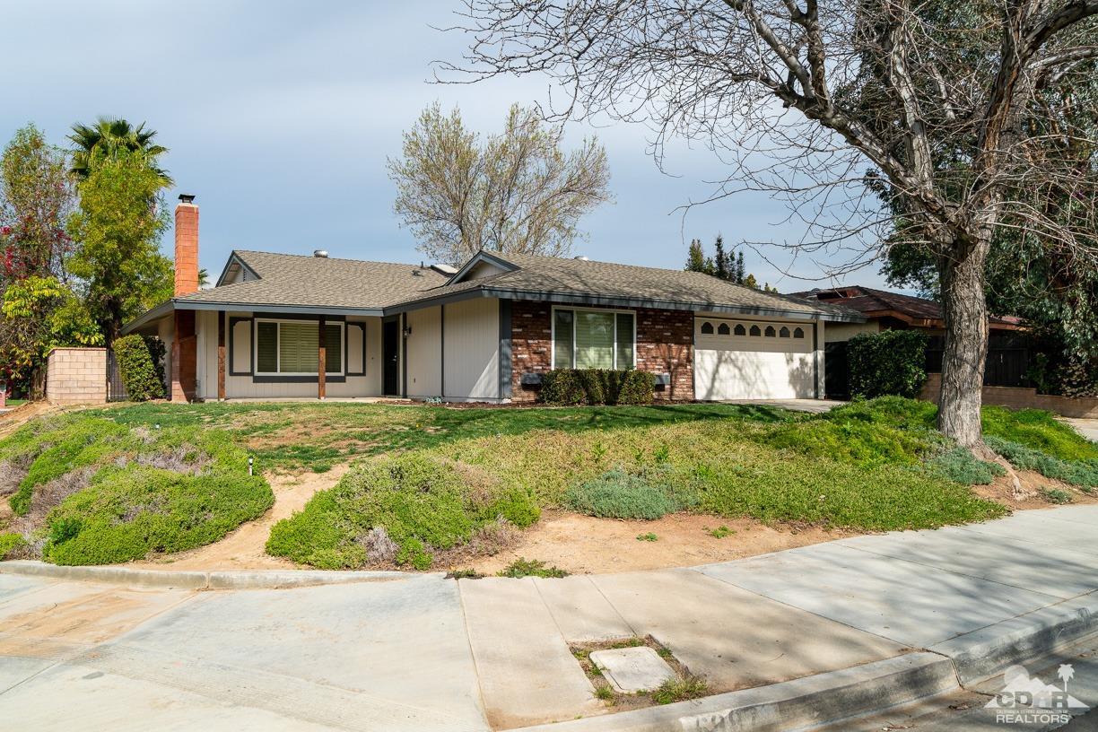 6987 Manhattan Drive Riverside, CA 92506 - Photo 20 of 28 a front view of a house with a garden