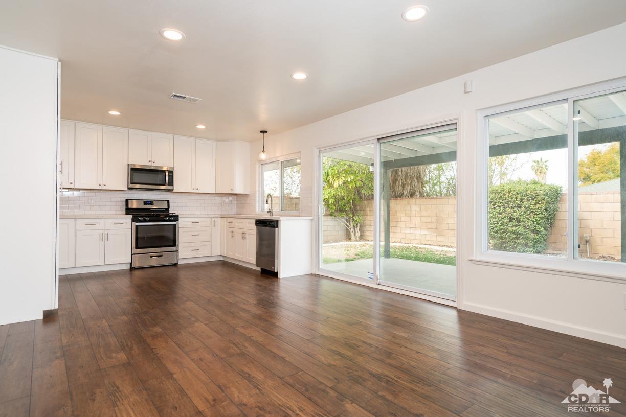 6987 Manhattan Drive Riverside, CA 92506 - Photo 3 of 28 a view of kitchen with stainless steel appliances wooden floor and stove