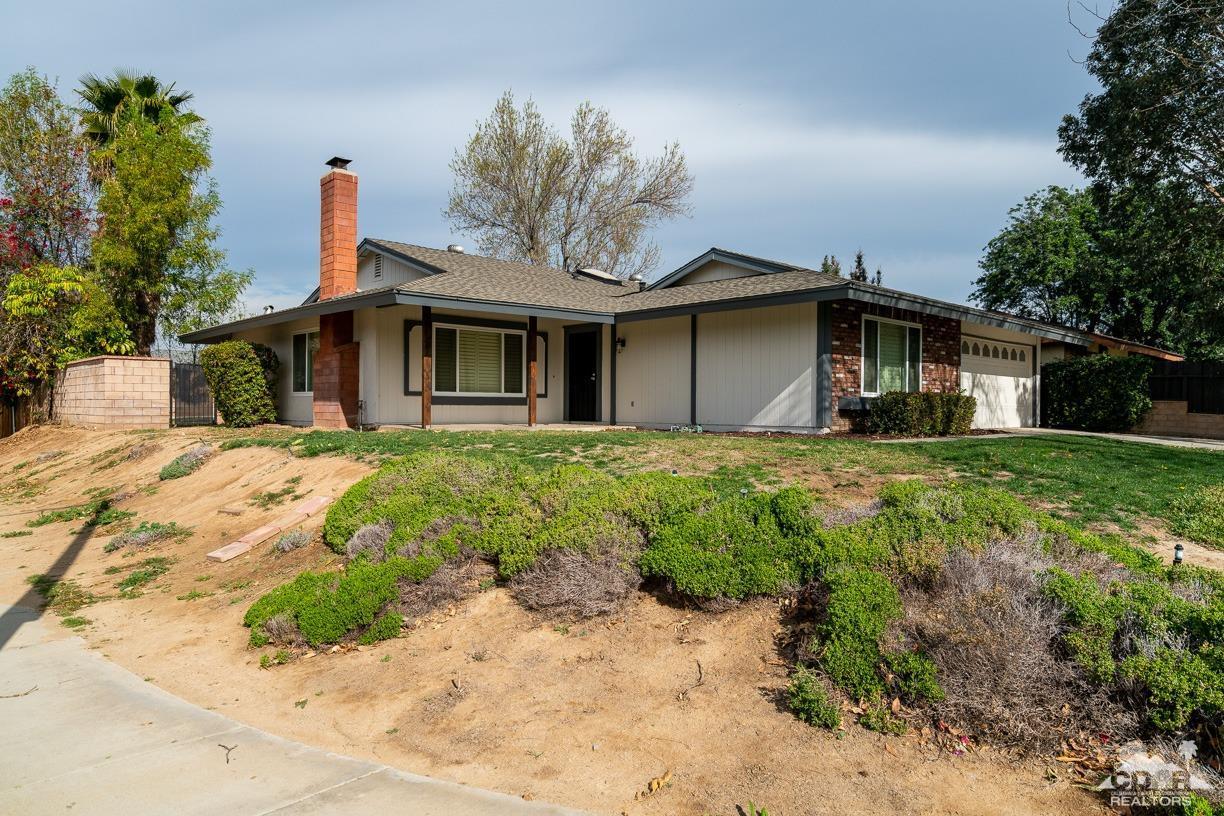 6987 Manhattan Drive Riverside, CA 92506 - Photo 21 of 28 a front view of a house with a garden