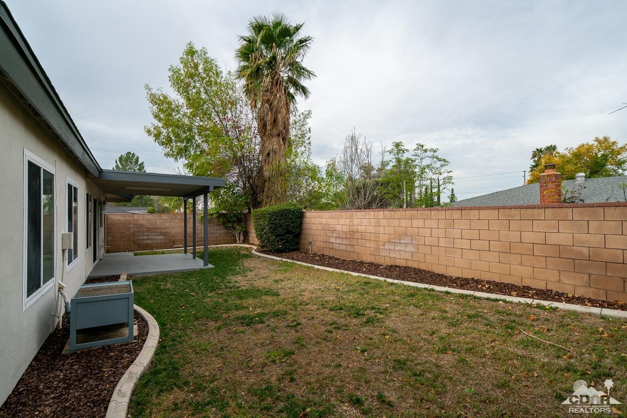 6987 Manhattan Drive Riverside, CA 92506 - Photo 26 of 28 a view of a backyard with plants and large trees
