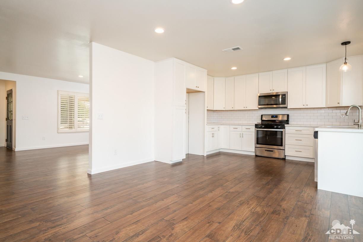 6987 Manhattan Drive Riverside, CA 92506 - Photo 4 of 28 a view of kitchen with microwave and stove