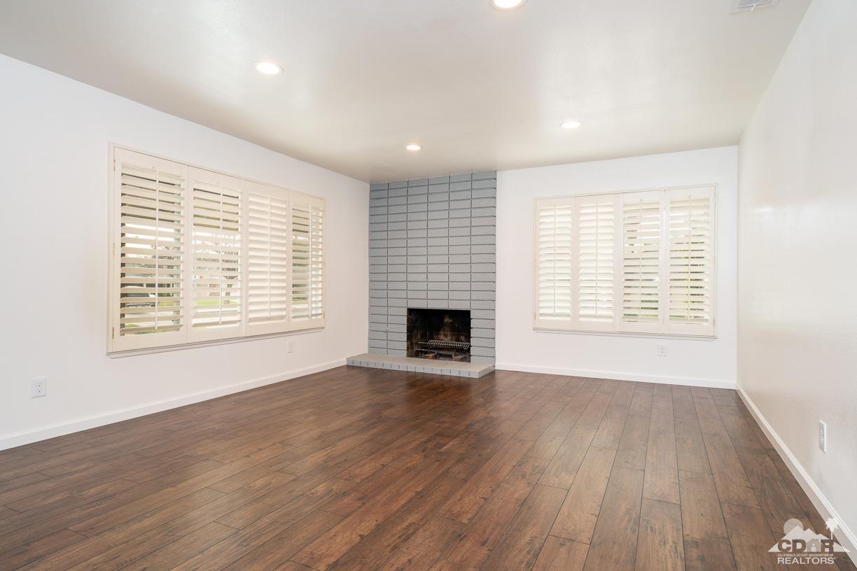 6987 Manhattan Drive Riverside, CA 92506 - Photo 6 of 28 an empty room with windows and a fireplace