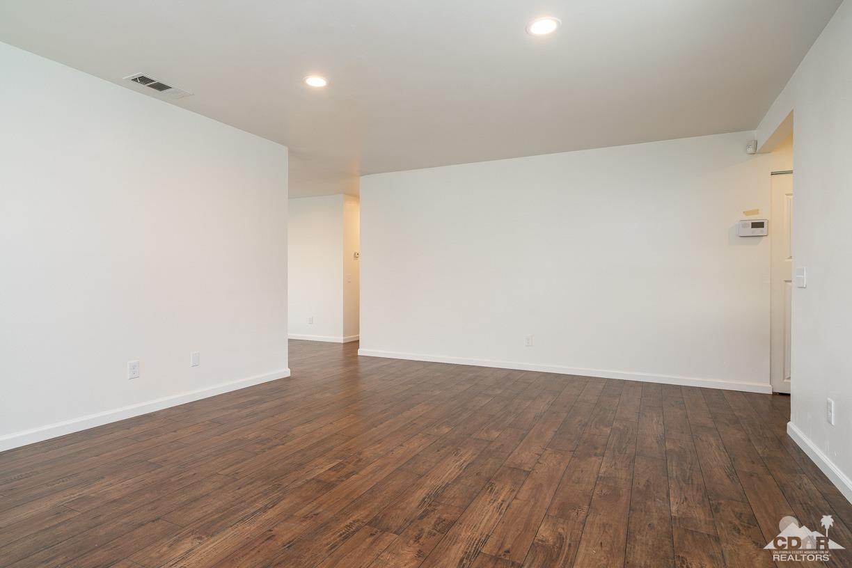 6987 Manhattan Drive Riverside, CA 92506 - Photo 8 of 28 a view of an empty room with wooden floor