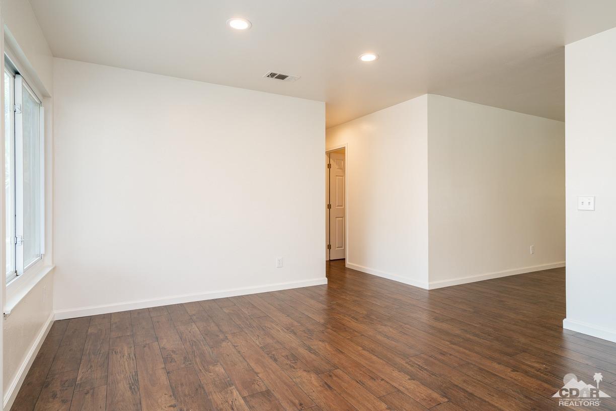 6987 Manhattan Drive Riverside, CA 92506 - Photo 10 of 28 a view of an empty room with wooden floor