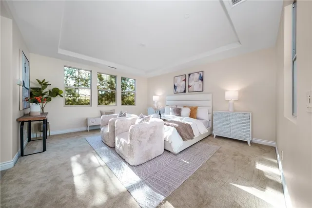 a bedroom with a large bed and potted plant