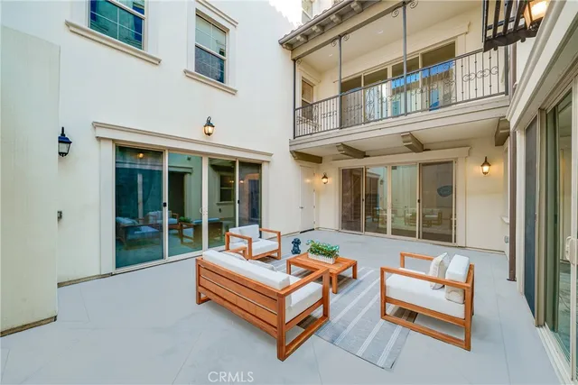 a view of a yard with plants and palm trees