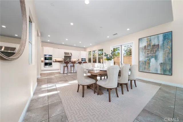 a dining room with a table and chairs