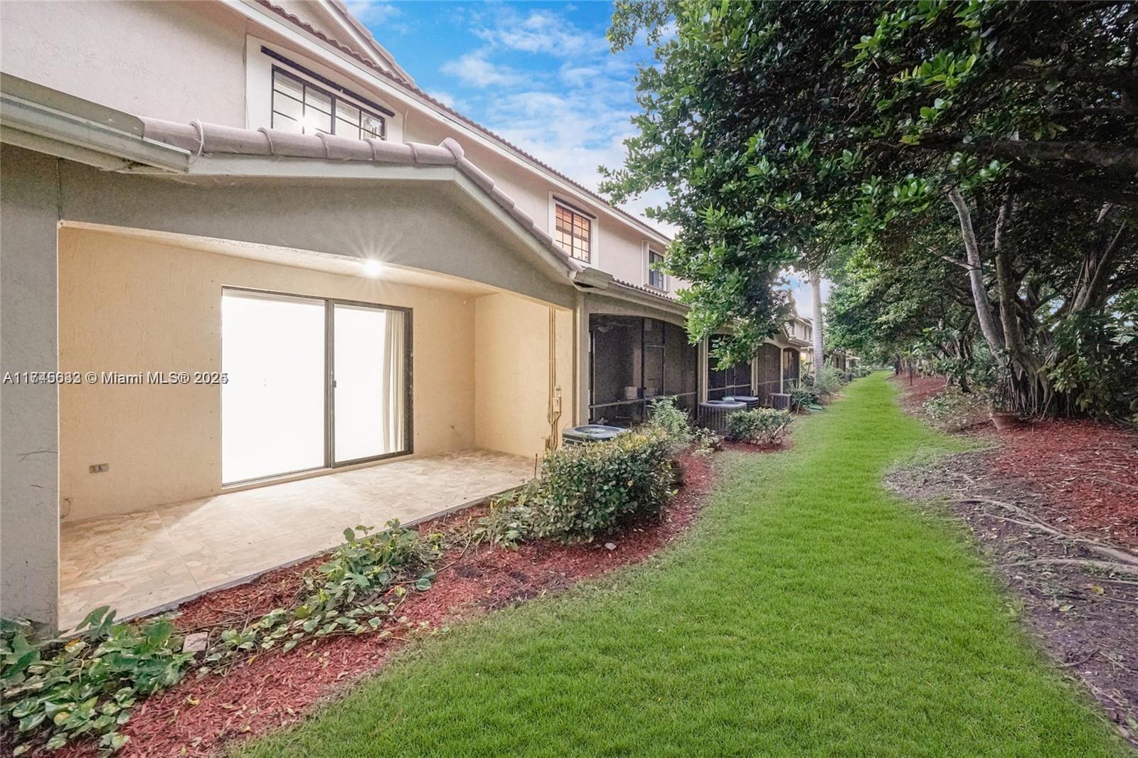 3903 Tree Top Drive Weston, FL 33332 - Photo 16 of 18 a view of a house with a yard