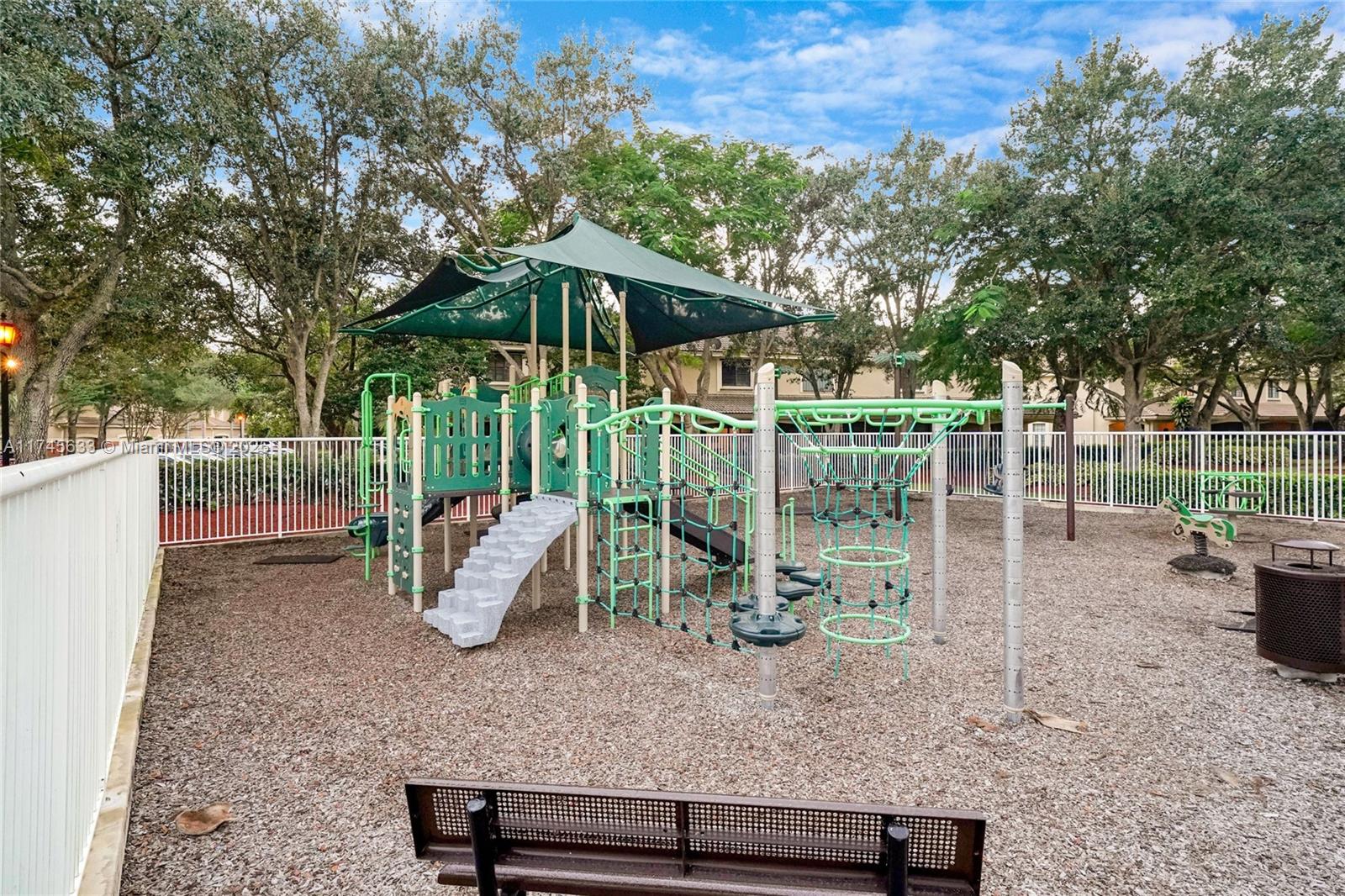 3903 Tree Top Drive Weston, FL 33332 - Photo 18 of 18 a view of a wooden deck with a bench