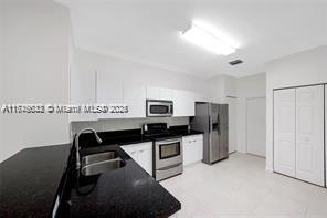3903 Tree Top Drive Weston, FL 33332 - Photo 4 of 18 a kitchen with refrigerator and stove