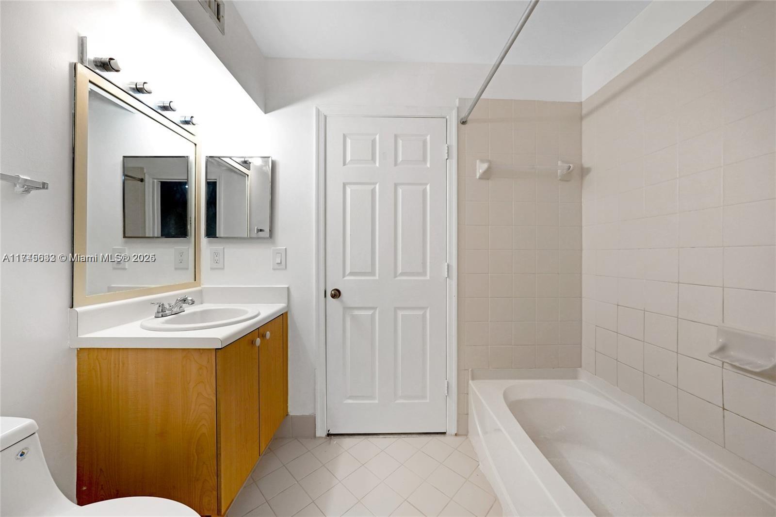 3903 Tree Top Drive Weston, FL 33332 - Photo 7 of 18 a bathroom with a sink a toilet and tub