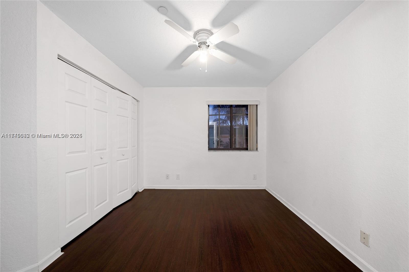 3903 Tree Top Drive Weston, FL 33332 - Photo 9 of 18 an empty room with a ceiling fan and wooden floor