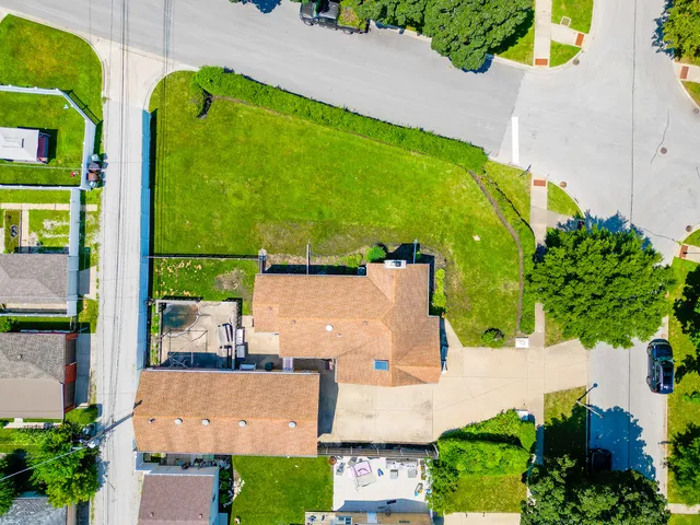an aerial view of a house with a swimming pool