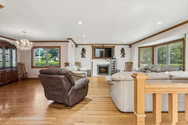 a living room with furniture flat screen tv and a large window