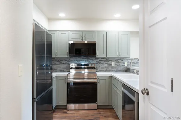 a kitchen with stainless steel appliances granite countertop a stove and a sink