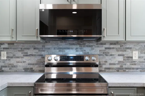 a stove top oven sitting inside of a kitchen