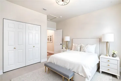 a bedroom with a bed and a lamp
