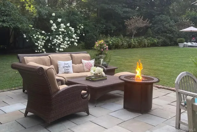 a view of a patio with couches chairs and a yard