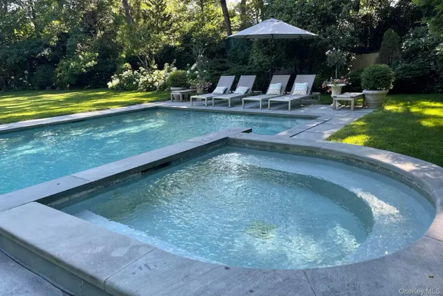 a view of a swimming pool with outdoor seating