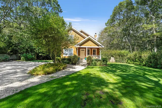 a view of backyard of house with green space