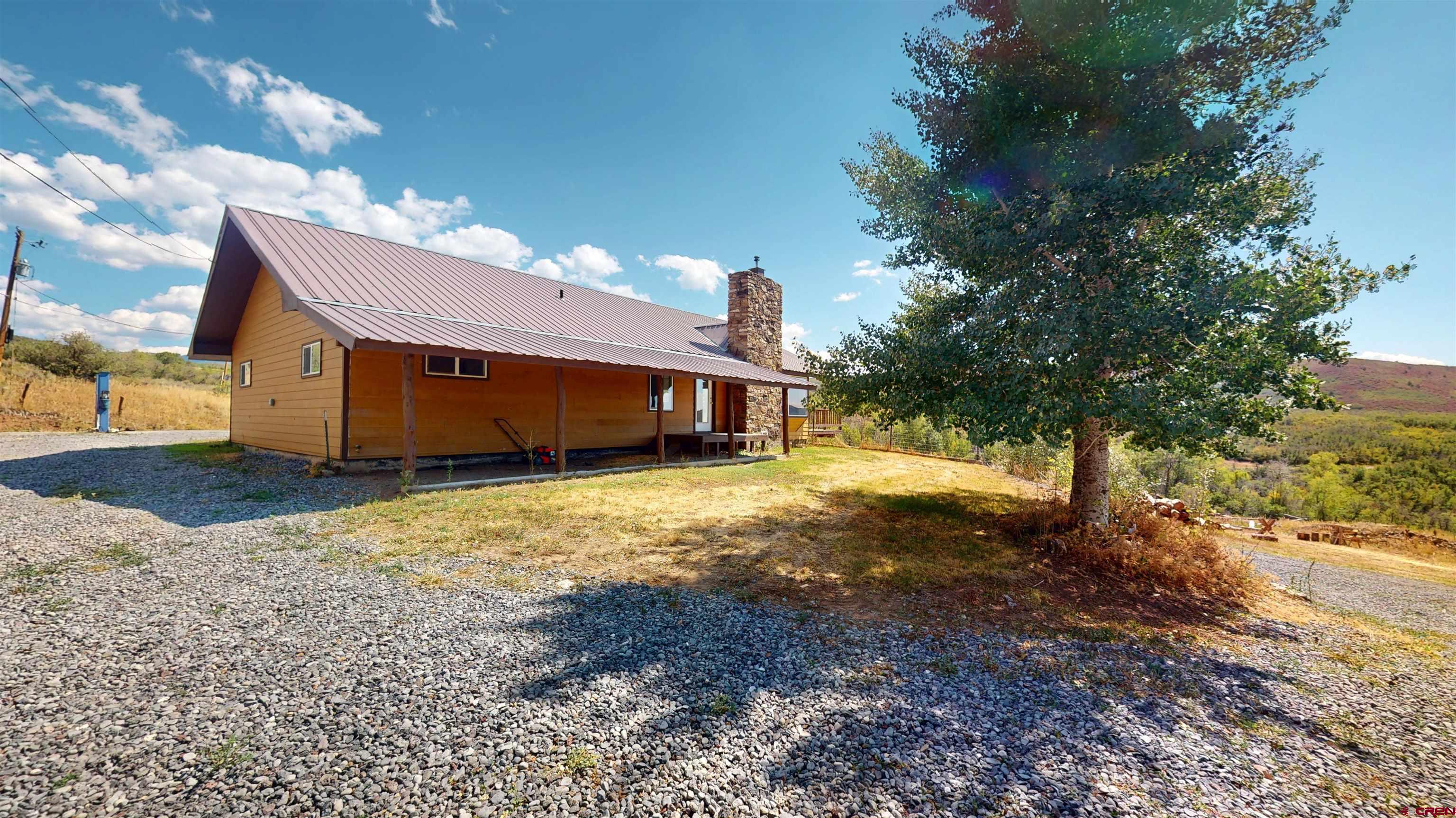 25615 Starner Loop Road Cedaredge, CO 81413 - Photo 38 of 42 a front view of a house with a yard
