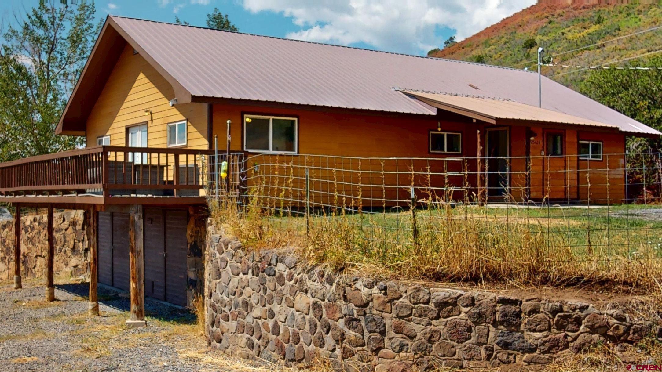 25615 Starner Loop Road Cedaredge, CO 81413 - Photo 41 of 42 a front view of a house with garden