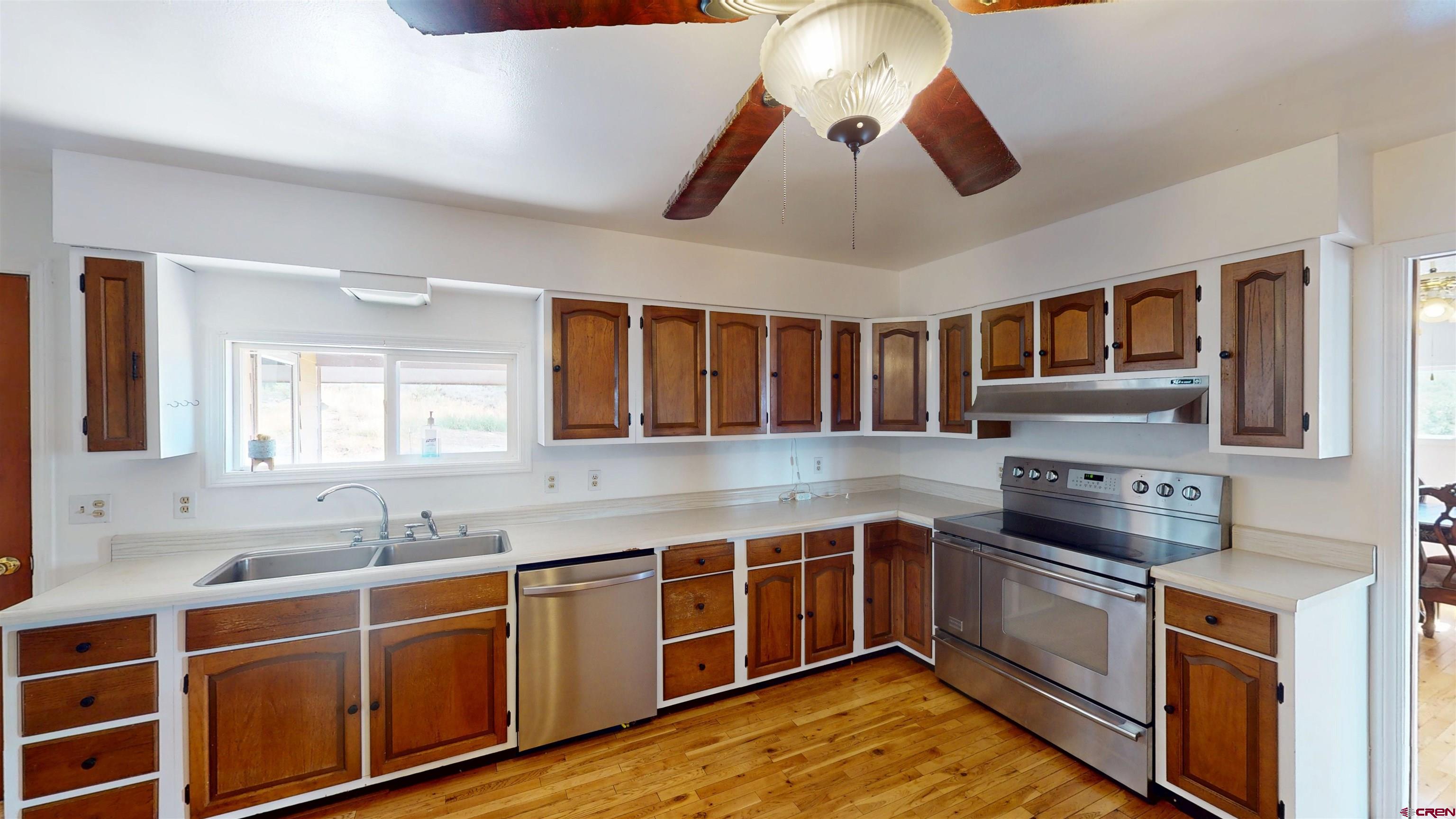 25615 Starner Loop Road Cedaredge, CO 81413 - Photo 10 of 42 a kitchen with stainless steel appliances granite countertop a stove and a sink