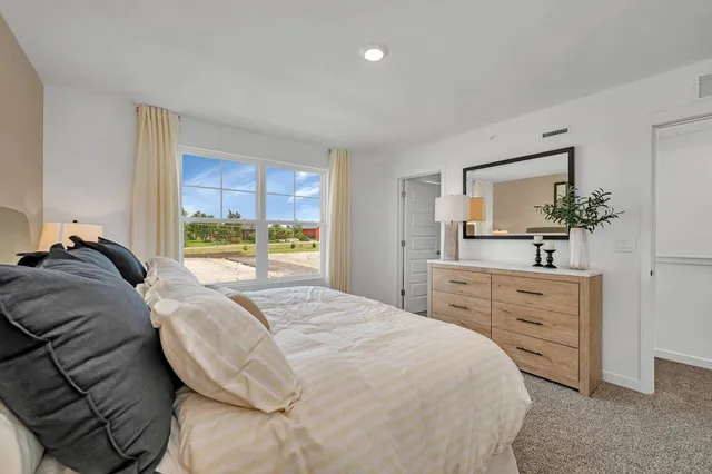 a bedroom with a bed and a dresser