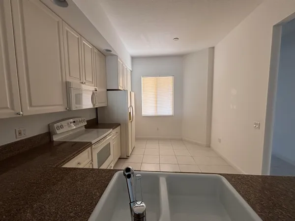 a view of a kitchen with electric appliances