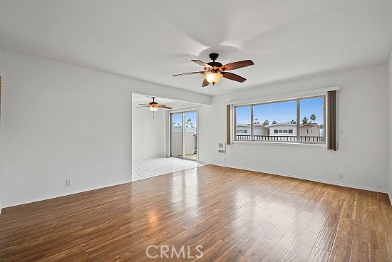 105 Alameda, Unit A San Clemente, CA 92672 - Photo 4 of 7 a view of an empty room with window and wooden floor
