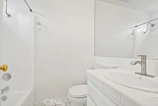 a bathroom with a toilet a sink and shower