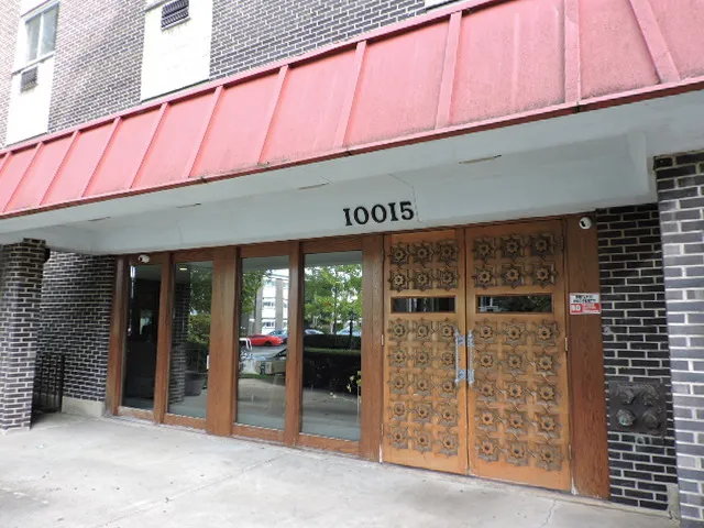 a front view of a building with glass door and an entrance